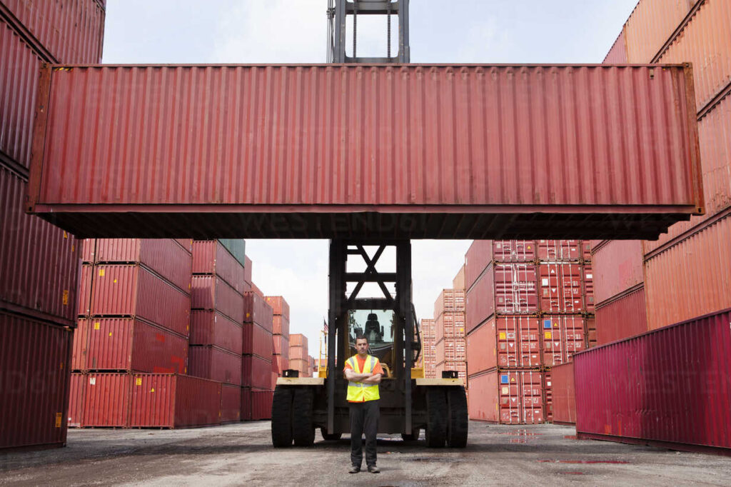 Employee Standing in Front of a Raised Freight Container